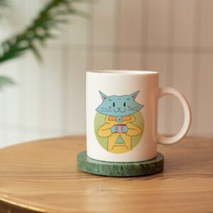 Cat Bud Mug is a plain white mug with an illustration of a cute blue cat sipping on a hot beverage